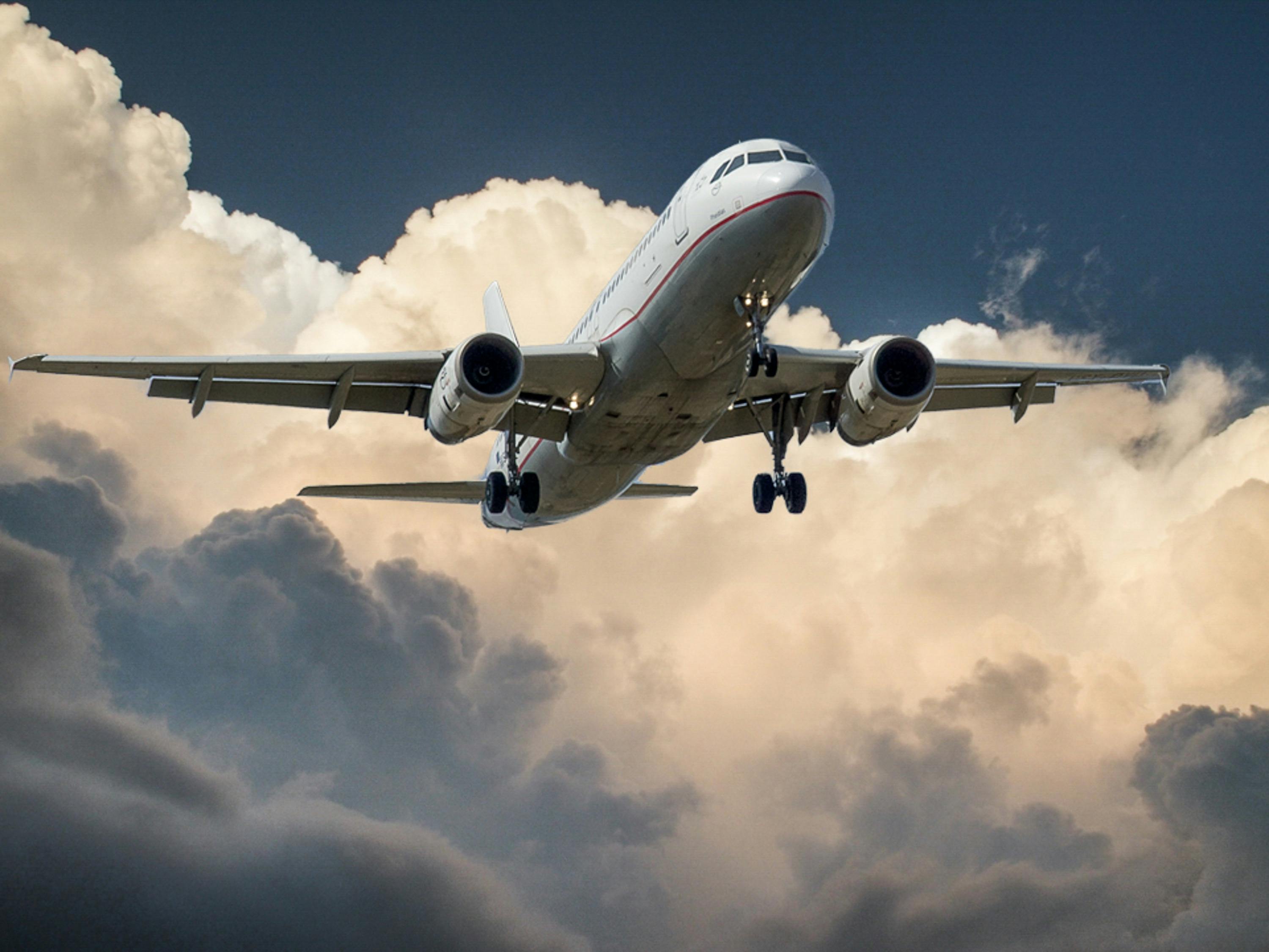 FlyDreamAir airplane flying through clouds